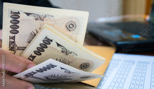 Woman is counting money with statement paper financial concept.
