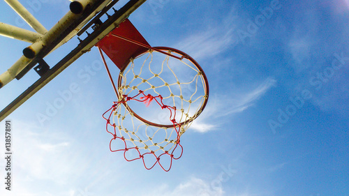 Outdoor basketball hoop with sky photo