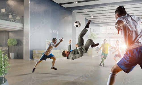 Playing football in office    . Mixed media