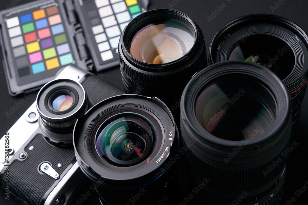 Close up photo of Collection of camera lens well organized over black background.