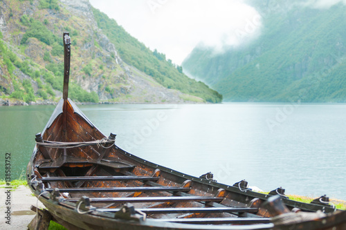 Vászonkép Old wooden viking boat in norwegian nature