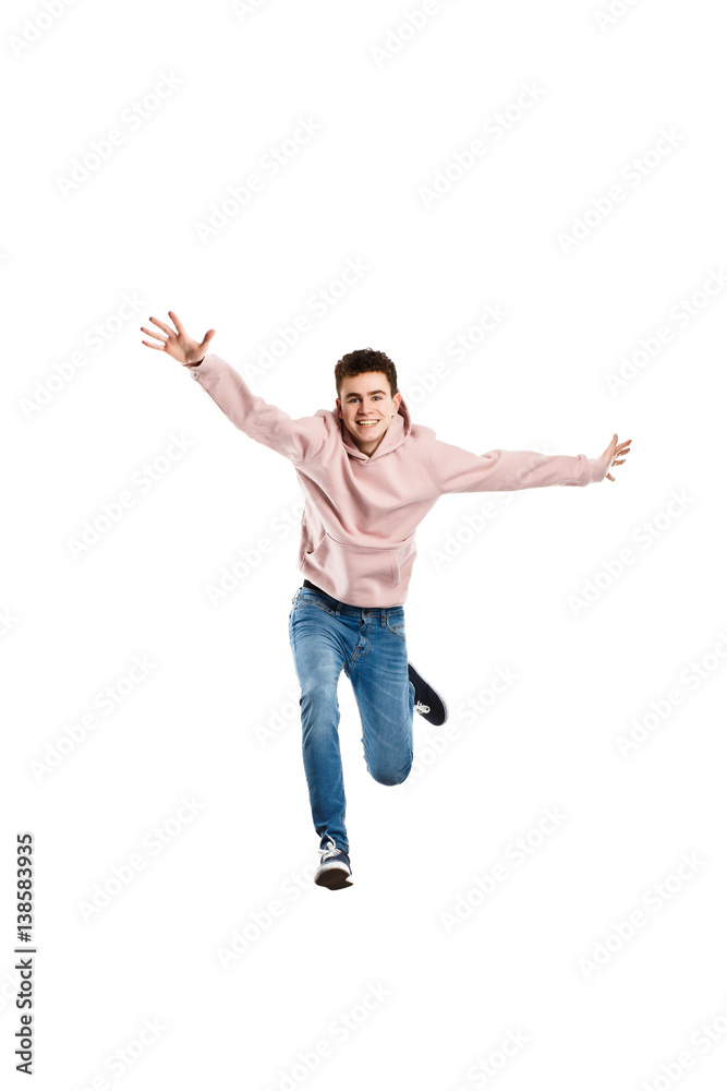 Young man jumping on white background 