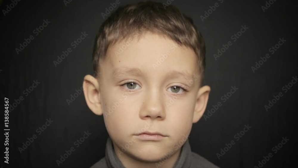 Portrait of a boy close-up on a black background. Full hd video Portrait of a boy close-up on a black background. Full hd video