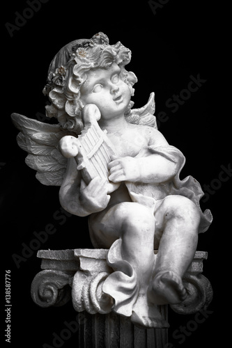 Statue of Little Cupid playing harp in black and white