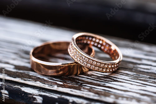 Golden wedding rings on wooden backrgound