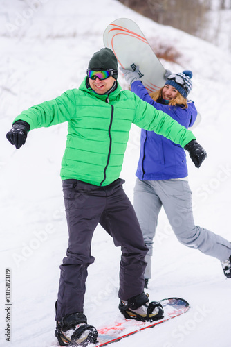 couple snowboarders playing and having fun in nature