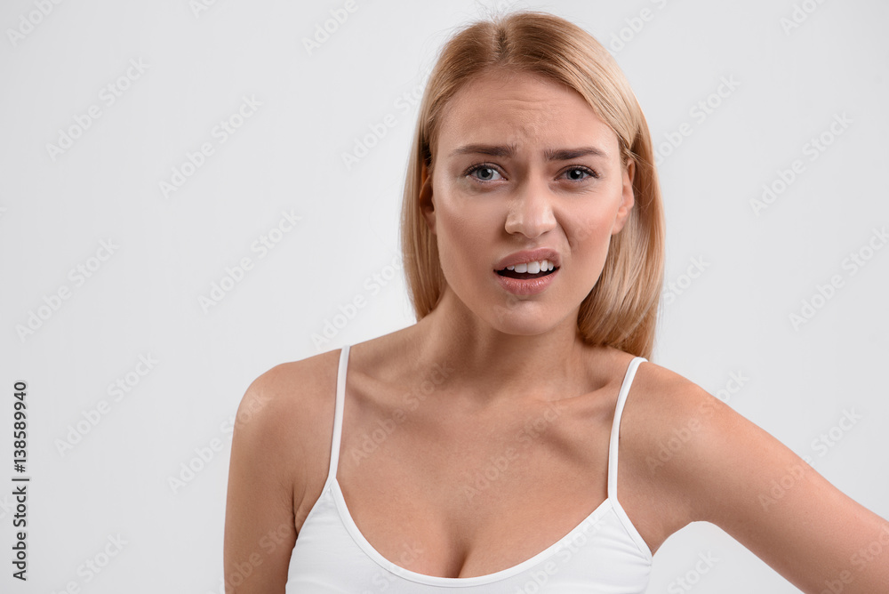Dissatisfied young woman posing with frustration Dissatisfied young woman posing with frustration