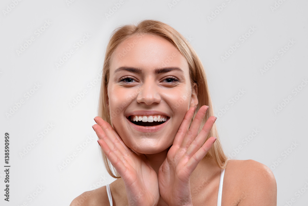 Cheerful blond girl likes skincare treatment Cheerful blond girl likes skincare treatment