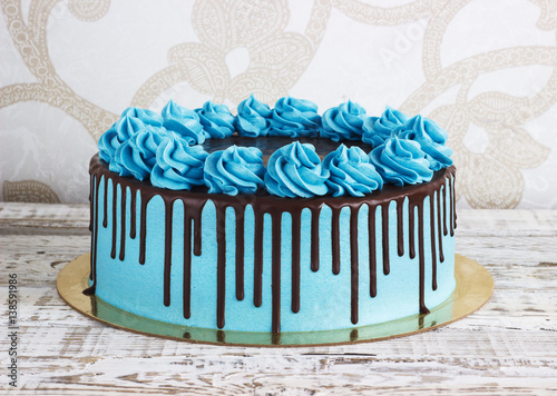 Birthday cake with cream chocolate drips on a white background