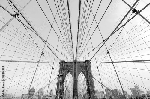 Perfect geometry of the Brooklyn Bridge cable web with overlook on Manhattan black and white monochrome retro photo