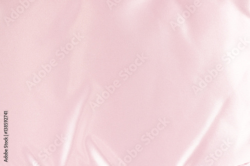 texture of pink cosmetic bag surface, made from satin-liked material, for pink abstract background pattern