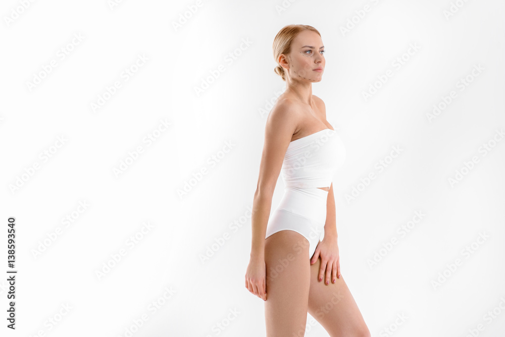 Sensual young woman standing in tight lingerie Sensual young woman standing in tight lingerie