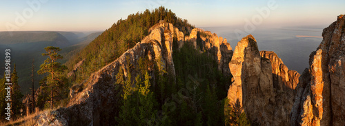 Sheer limestone cliffs and forest. National Park Lena pillars. Yakutia. Russia.