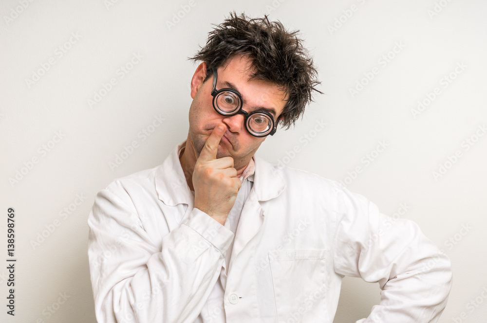 Crazy scientist thinking about his experiment Crazy scientist thinking about his experiment