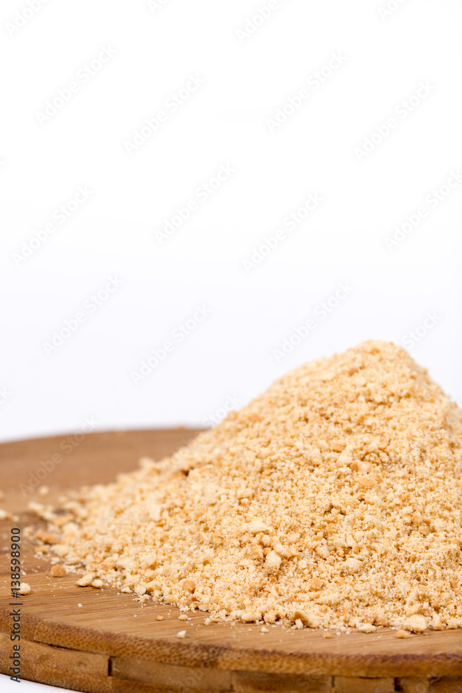 Pile of grounded biscuits on the wooden board Pile of grounded biscuits on the wooden board