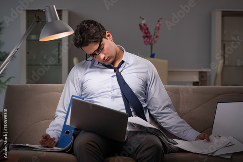 Businessman workaholic working late at home photo