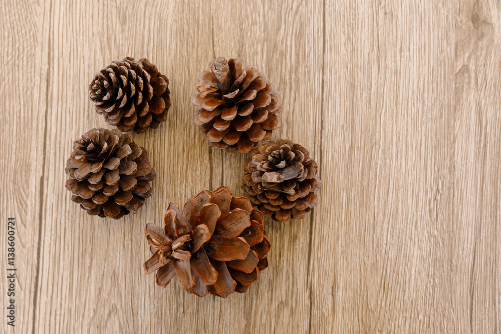 Pine cones placed on a wooden table Pine cones placed on a wooden table