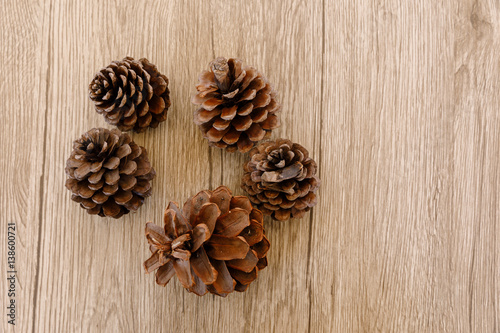 Pine cones placed on a wooden table