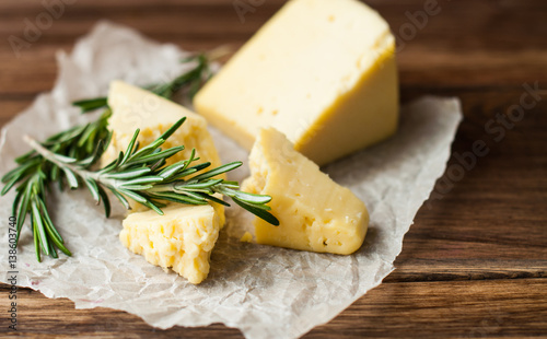 Hard cheese on a wooden table. Dairy products and agriculture.
