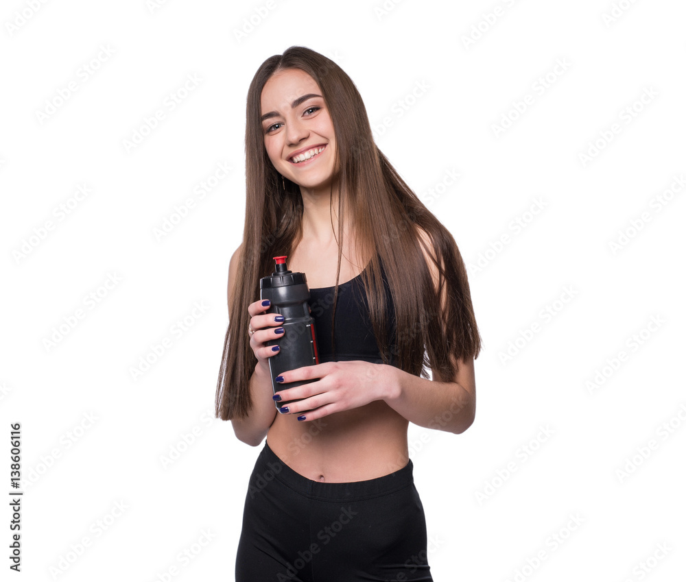 Portrait of smiling young sporty woman with a bottle of water posing in studio isolated on white background. Portrait of smiling young sporty woman with a bottle of water posing in studio isolated on white background.