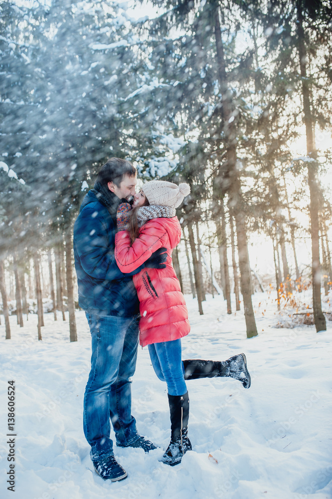 Guy and girl walk ,have fun in the forest in winter Guy and girl walk ,have fun in the forest in winter