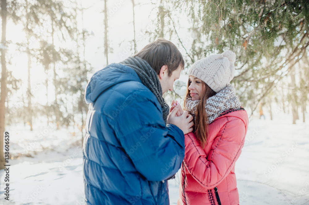 Man with a woman walking in the winter snow park Man with a woman walking in the winter snow park