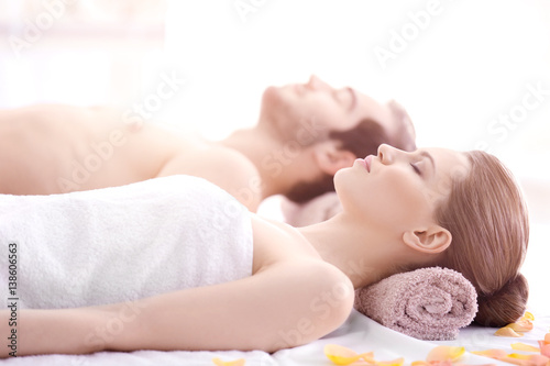 Young happy couple relaxing in spa salon