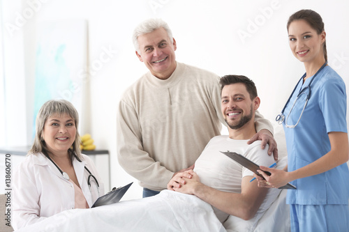 Doctors visiting patient in hospital