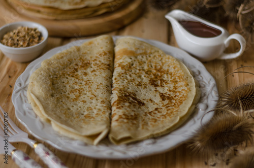 Pancakes with chocolate sauce and nuts for breakfast