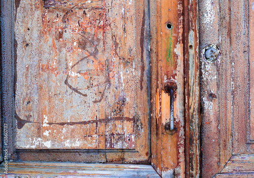 Weathered, wooden door in an old abandoned building