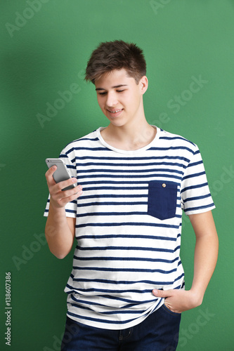 Teenage boy with mobile pho...