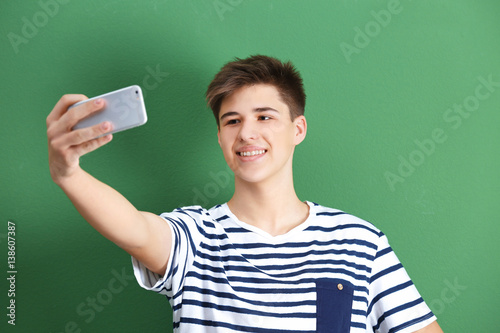 Teenage boy making selfie w...