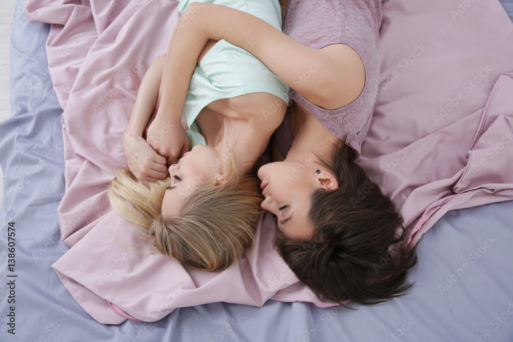 Young lesbian couple sleeping on bed at home Young lesbian couple sleeping on bed at home