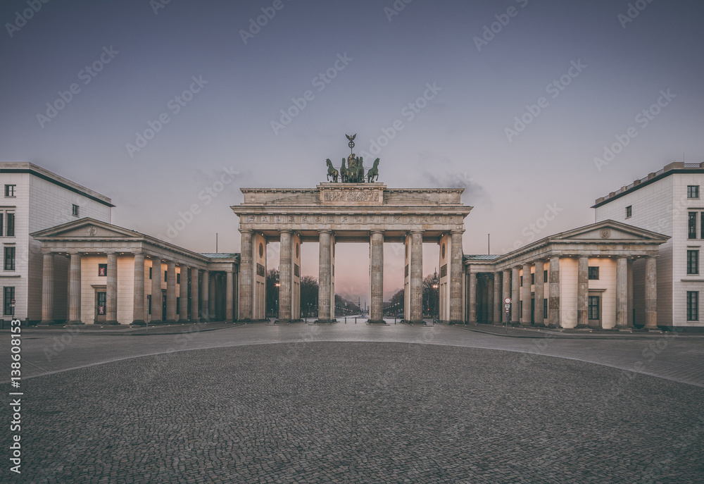 Colorful sunrise at the Brandenburg Gate in Berlin, Germany in February, vintage filtered style