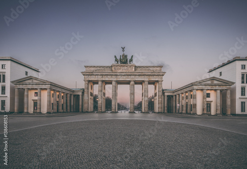 Colorful sunrise at the Brandenburg Gate in Berlin  Germany in February  vintage filtered style