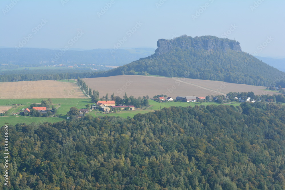 Naklejka premium View on fields, villages and farms from Festung Konigstein fortress, Saxon Switzerland, Bavaria, Germany. Famous tourist and travel routes. Natural lighting.