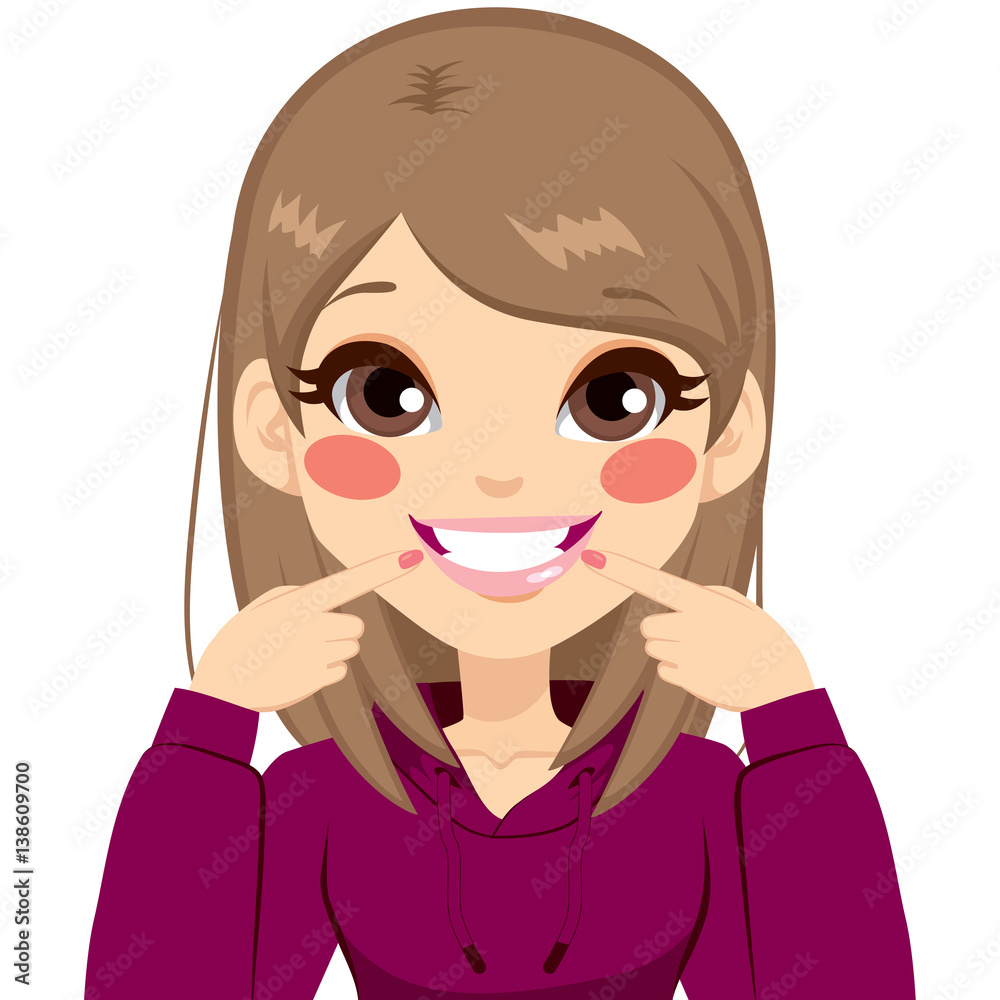 Beautiful young teenager happy girl smiling showing her pretty white smile pointing fingers at mouth Beautiful young teenager happy girl smiling showing her pretty white smile pointing fingers at mouth