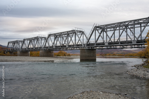 Railway bridge surrounded by autumn landscapes. Polar Urals. Russia.