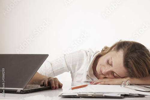 tired woman sleeping at the workplace (excessive work, overwork, stress, health)