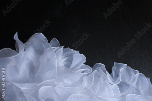 Fotografie hem of a wedding dress on a black background
