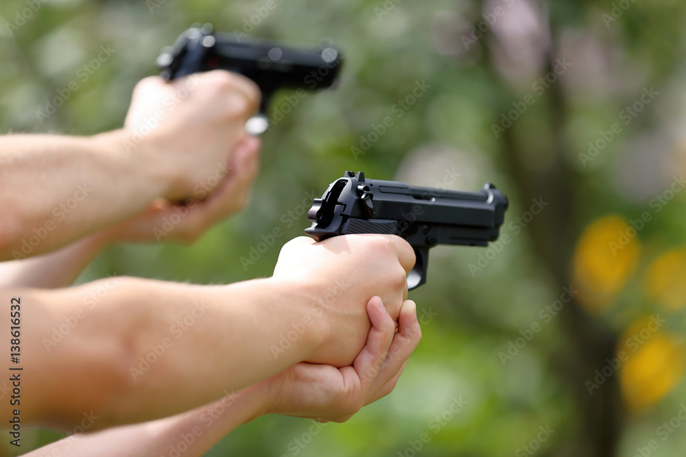 Young boys practice shooting guns on outdoor Young boys practice shooting guns on outdoor