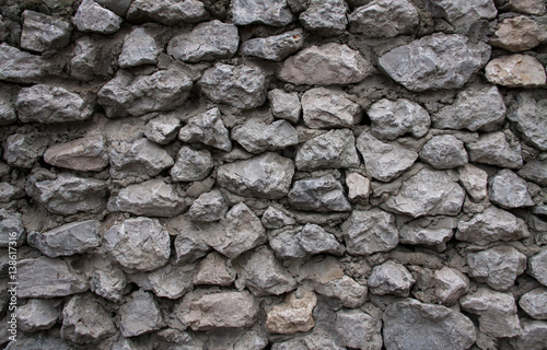 The wall made of gray stones and cement