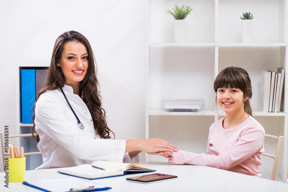 Portrait of female doctor and child holding hands at the medical office. Portrait of female doctor and child holding hands at the medical office.