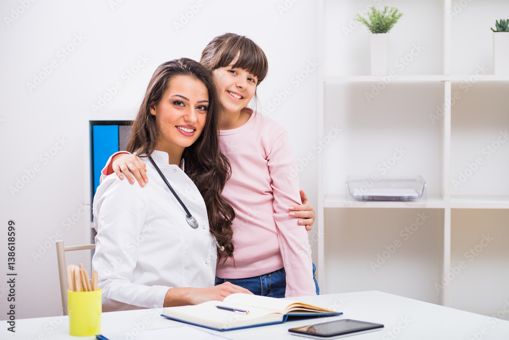Portrait of happy child and female doctor embracing at the medical office. Portrait of happy child and female doctor embracing at the medical office.