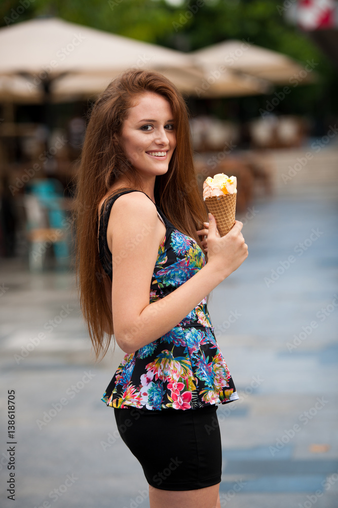 Young woman with ice cream in city on hot late summer afternoon Young woman with ice cream in city on hot late summer afternoon