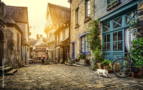 Fototapeta Naklejka Na Ścianę i Meble -  Charming street scene in an old town in Europe at sunset