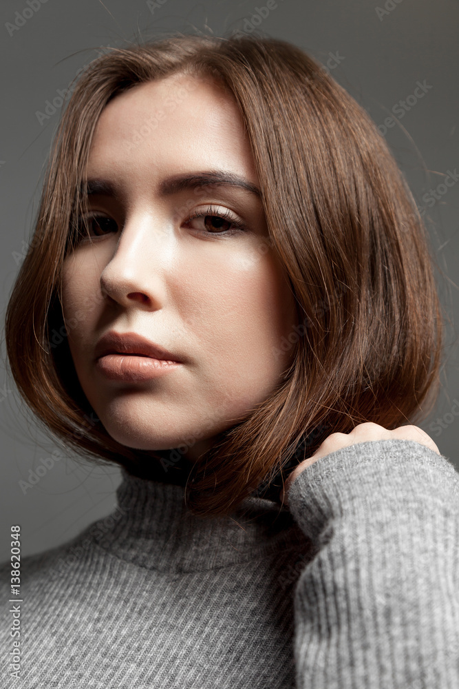 Portrait of a young girl model with clear skin, looking at the camera. Portrait of a young girl model with clear skin, looking at the camera.