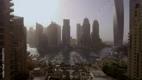 beautiful aerial view on bay with yachts and embankment among the skyscrapers in Dubai, UAE photo