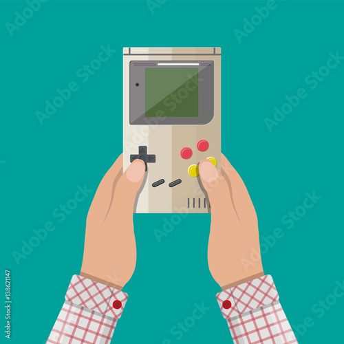 Wallpaper Mural Old Gadget. Handheld game console in hands Torontodigital.ca