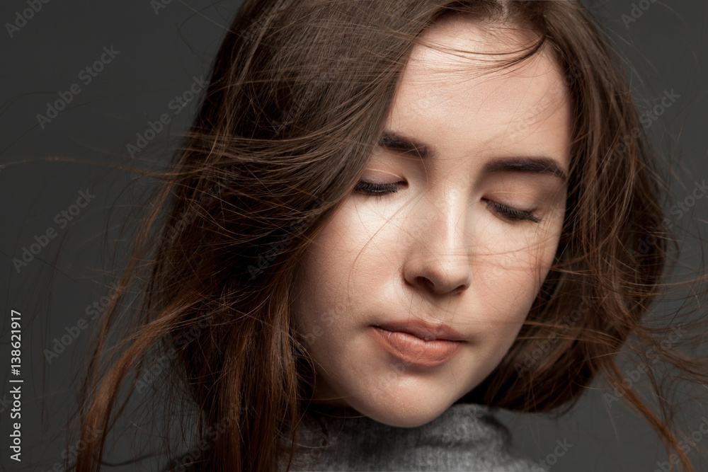 Close-up portrait of a young brunette cute girl with flying hair. Close-up portrait of a young brunette cute girl with flying hair.